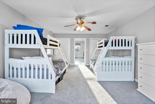 carpeted bedroom with a ceiling fan and baseboards