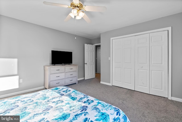 carpeted bedroom with baseboards, a ceiling fan, and a closet