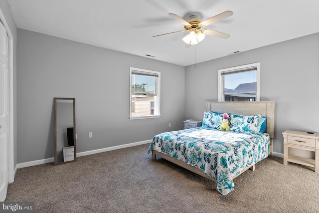 bedroom featuring baseboards, carpet flooring, and multiple windows