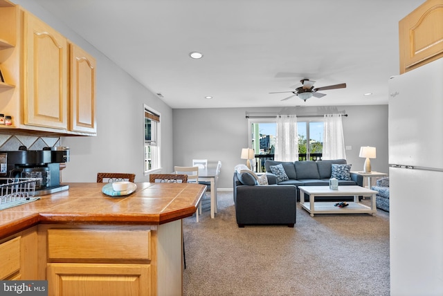 carpeted living area with recessed lighting and ceiling fan