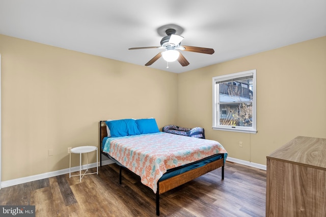 bedroom featuring baseboards, a ceiling fan, and wood finished floors