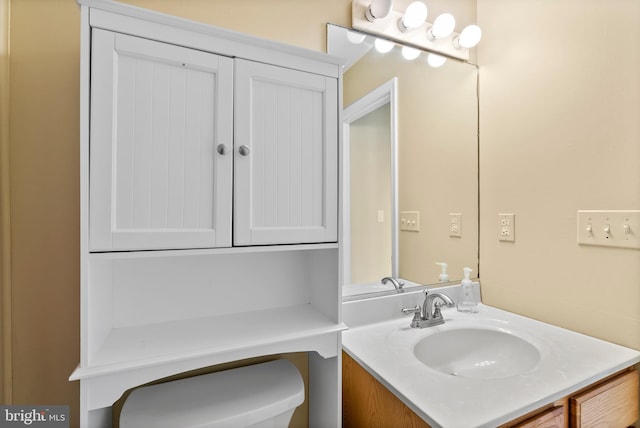 half bathroom featuring vanity and toilet
