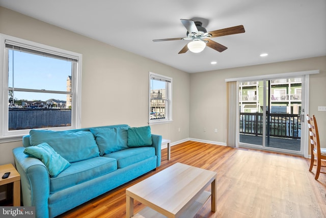 living area with baseboards, recessed lighting, ceiling fan, and wood finished floors