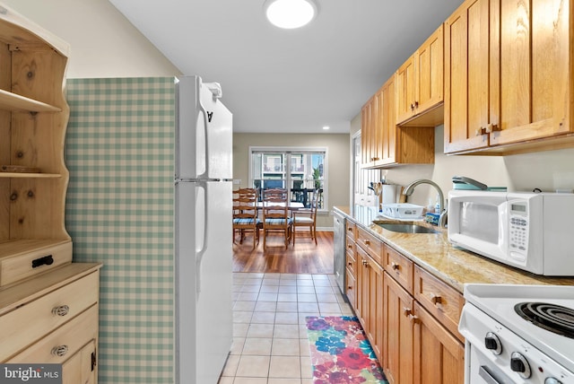 kitchen with white appliances, light tile patterned floors, open shelves, and a sink