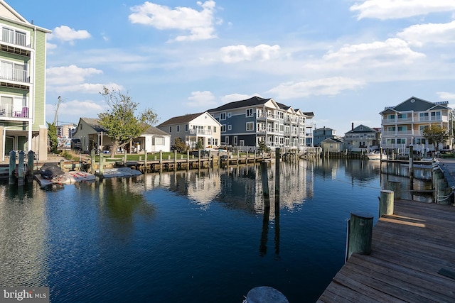view of dock featuring a water view and a residential view