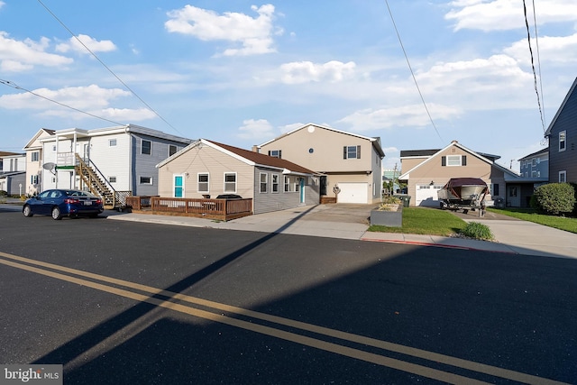 view of front of property with an attached garage, driveway, and a residential view