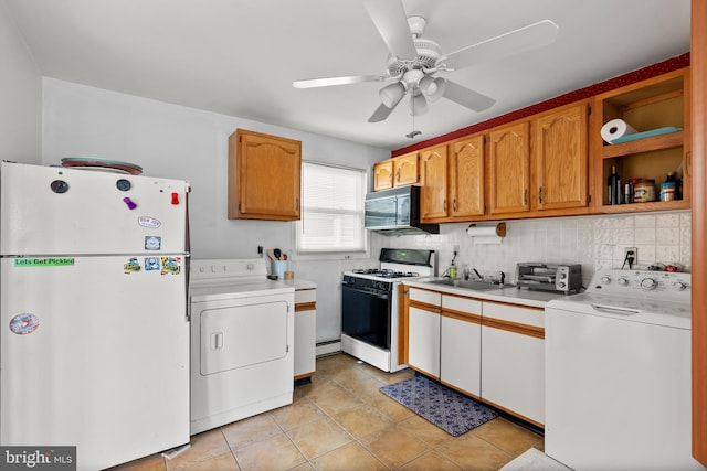 kitchen with a sink, washer / clothes dryer, white appliances, and light countertops