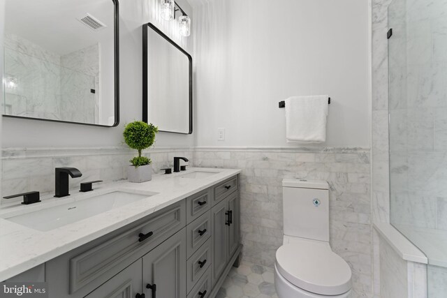 5123 8th St NW, Washington, DC 20011 - bathroom featuring tile walls, visible vents, a sink, and toilet