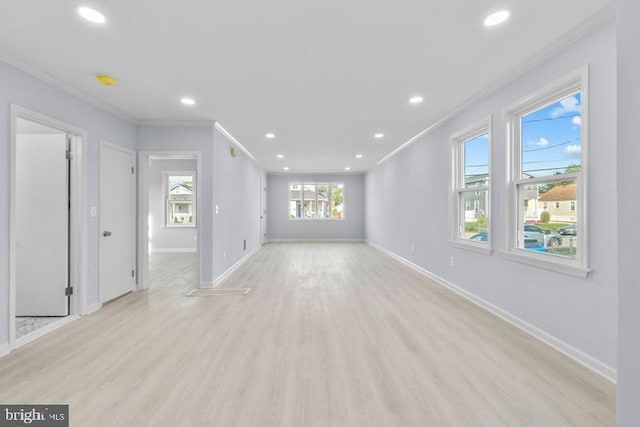 unfurnished living room featuring crown molding, baseboards, recessed lighting, and light wood-type flooring