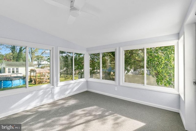 unfurnished sunroom with baseboards, carpet floors, and lofted ceiling