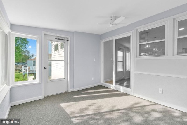 interior space featuring baseboards and ceiling fan