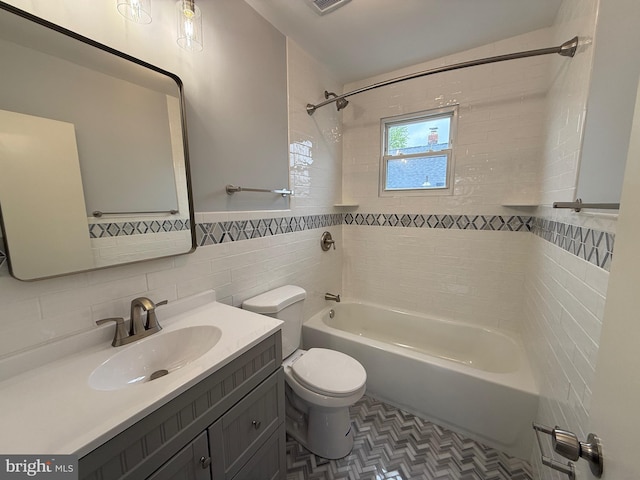 bathroom featuring vanity, toilet, tile walls, shower / washtub combination, and visible vents