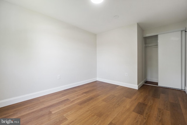 115 Pates Dr, Fort Washington, MD 20744 - unfurnished bedroom featuring wood finished floors, a closet, and baseboards