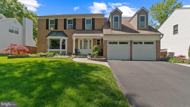 2317 Nantucket Dr, Crofton, MD 21114 - view of front of house with an attached garage, a front yard, driveway, and brick siding
