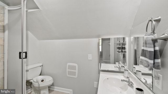 2317 Nantucket Dr, Crofton, MD 21114 - bathroom with a sink, tile patterned floors, vaulted ceiling, and toilet