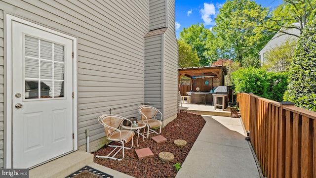 2317 Nantucket Dr, Crofton, MD 21114 - view of exterior entry featuring fence, a pergola, a jacuzzi, and a patio area