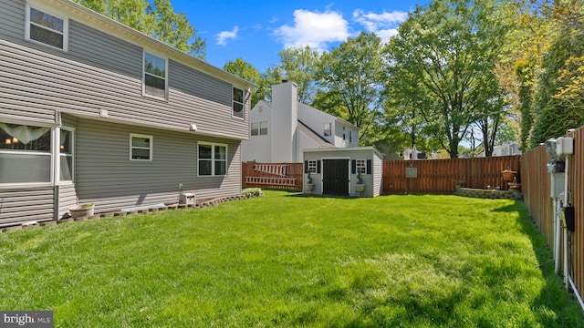 2317 Nantucket Dr, Crofton, MD 21114 - back of property with a lawn, a fenced backyard, an outbuilding, and a storage unit