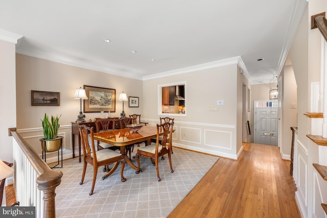 4360 Westover Pl NW, Washington, DC 20016 - dining area with a decorative wall, recessed lighting, crown molding, wainscoting, and light wood-style floors