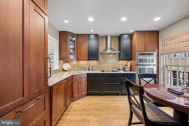 4360 Westover Pl NW, Washington, DC 20016 - kitchen with a sink, tasteful backsplash, stainless steel double oven, light stone counters, and wall chimney exhaust hood