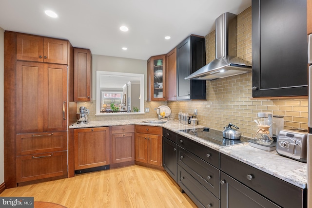 4360 Westover Pl NW, Washington, DC 20016 - kitchen with a sink, light wood-type flooring, wall chimney exhaust hood, backsplash, and black electric cooktop