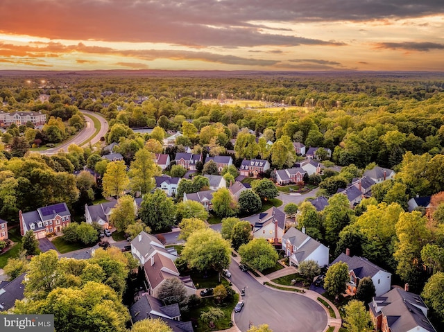 birds eye view of property featuring a wooded view and a residential view