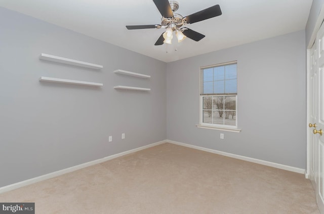 unfurnished room with a ceiling fan, baseboards, and carpet floors
