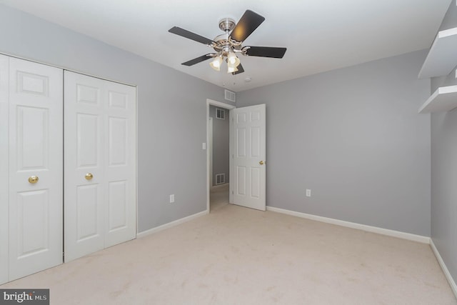 unfurnished bedroom featuring visible vents, baseboards, and light carpet