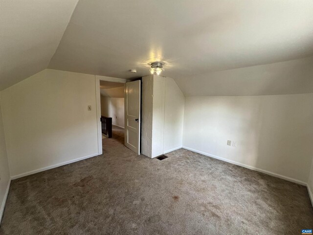 bonus room with baseboards, carpet flooring, and lofted ceiling