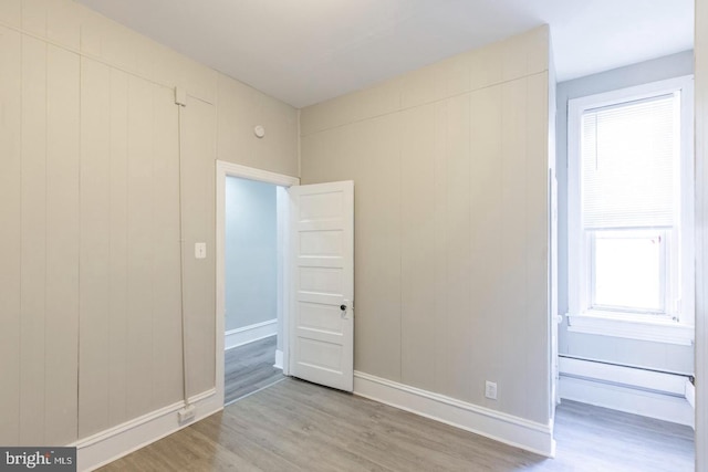3547 N 21st St, Philadelphia, PA 19140 - unfurnished room with baseboard heating, wood finished floors, and baseboards