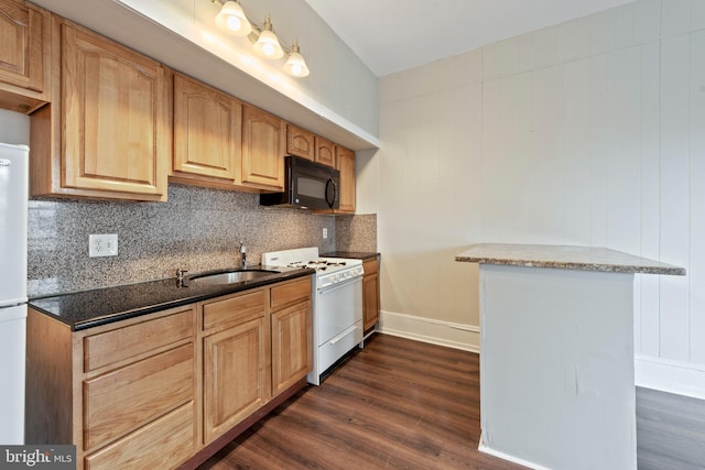 3547 N 21st St, Philadelphia, PA 19140 - kitchen featuring dark stone counters, a sink, dark wood-style flooring, decorative backsplash, and white appliances