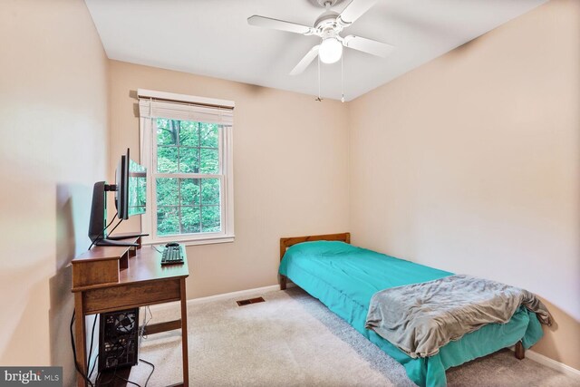 carpeted bedroom with baseboards and ceiling fan