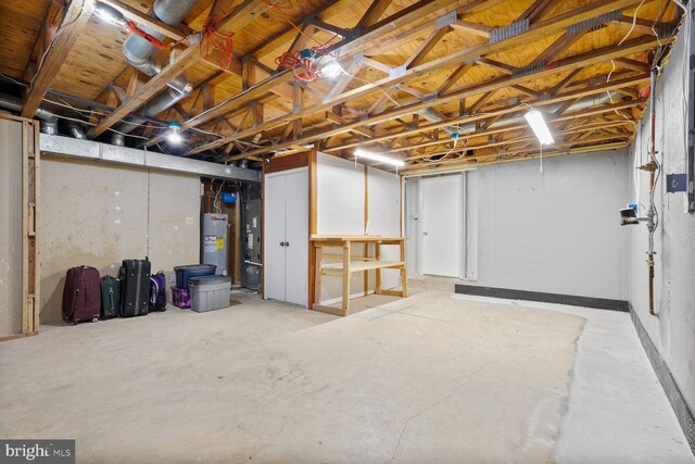 unfinished basement with electric water heater