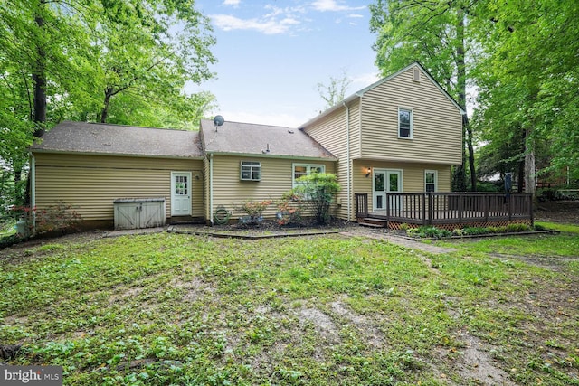 back of property featuring a wooden deck and a yard