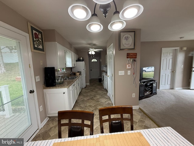1175 Brook Ct, Front Royal, VA 22630 - kitchen featuring a sink, white cabinets, baseboards, ceiling fan, and freestanding refrigerator