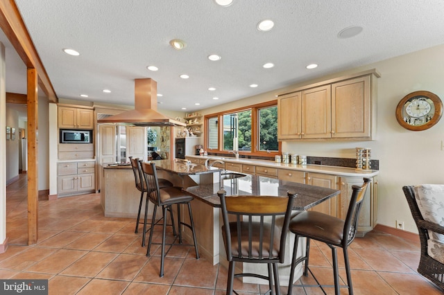 18291 Calumet Ln, Bluemont, VA 20135 - kitchen featuring stainless steel microwave, recessed lighting, island exhaust hood, a kitchen bar, and a center island with sink