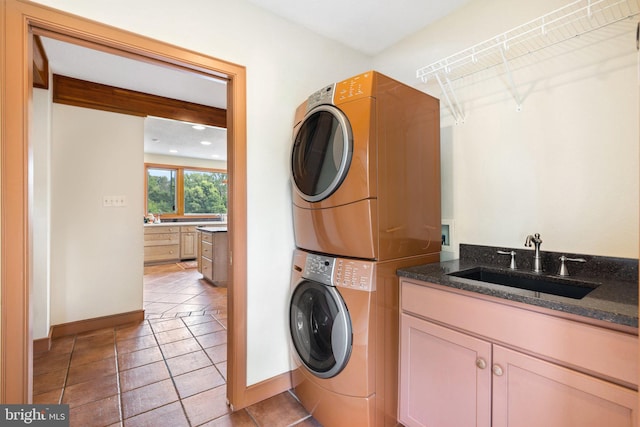 18291 Calumet Ln, Bluemont, VA 20135 - washroom featuring stacked washer / dryer, cabinet space, a sink, baseboards, and light tile patterned flooring