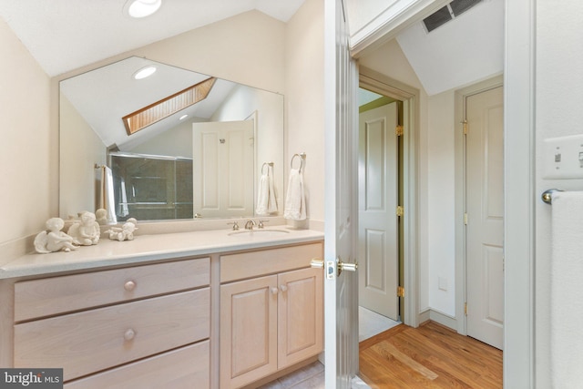 18291 Calumet Ln, Bluemont, VA 20135 - bathroom with wood finished floors, visible vents, vanity, and vaulted ceiling