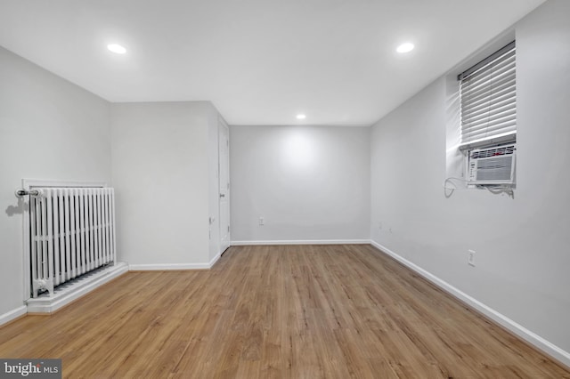 bonus room featuring recessed lighting, radiator heating unit, light wood finished floors, and baseboards