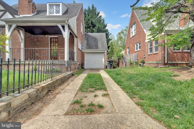 view of home's exterior featuring brick siding, a lawn, concrete driveway, and fence