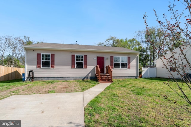 manufactured / mobile home with fence, crawl space, and a front lawn