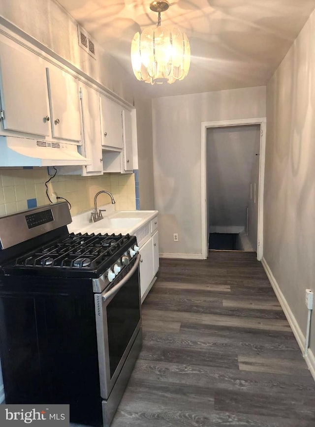 6162 Hasbrook Ave, Philadelphia, PA 19111 - kitchen with under cabinet range hood, stainless steel gas stove, visible vents, baseboards, and white cabinetry