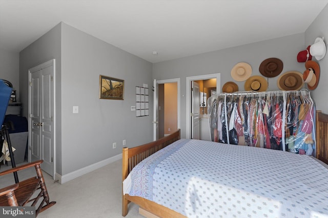 bedroom with baseboards and light carpet