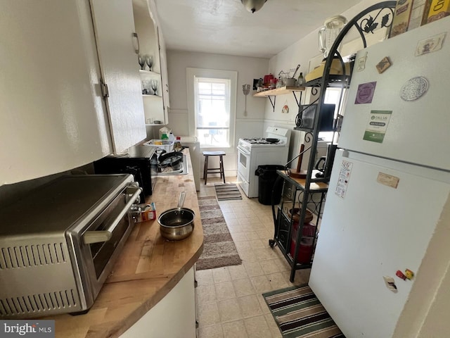 611 Truitt St, Salisbury, MD 21804 - kitchen featuring open shelves, light floors, white appliances, and a toaster