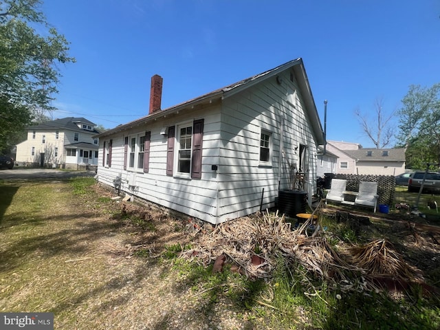 611 Truitt St, Salisbury, MD 21804 - view of property exterior with a chimney, central air condition unit, and fence