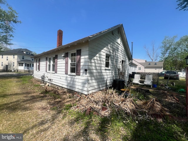 611 Truitt St, Salisbury, MD 21804 - view of property exterior featuring a chimney and central AC