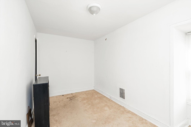 spare room featuring baseboards and visible vents