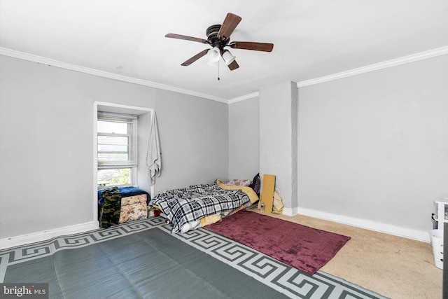 bedroom featuring baseboards, ornamental molding, a ceiling fan, and carpet floors
