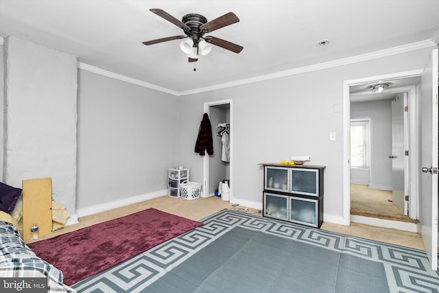 bedroom featuring baseboards, ornamental molding, a ceiling fan, and carpet flooring