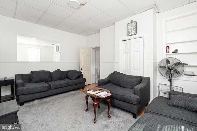 living area featuring a paneled ceiling