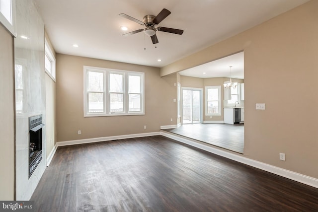 265 S Charleston Ave, Lawnside, NJ 08045 - unfurnished living room with recessed lighting, ceiling fan with notable chandelier, a fireplace, baseboards, and dark wood-type flooring